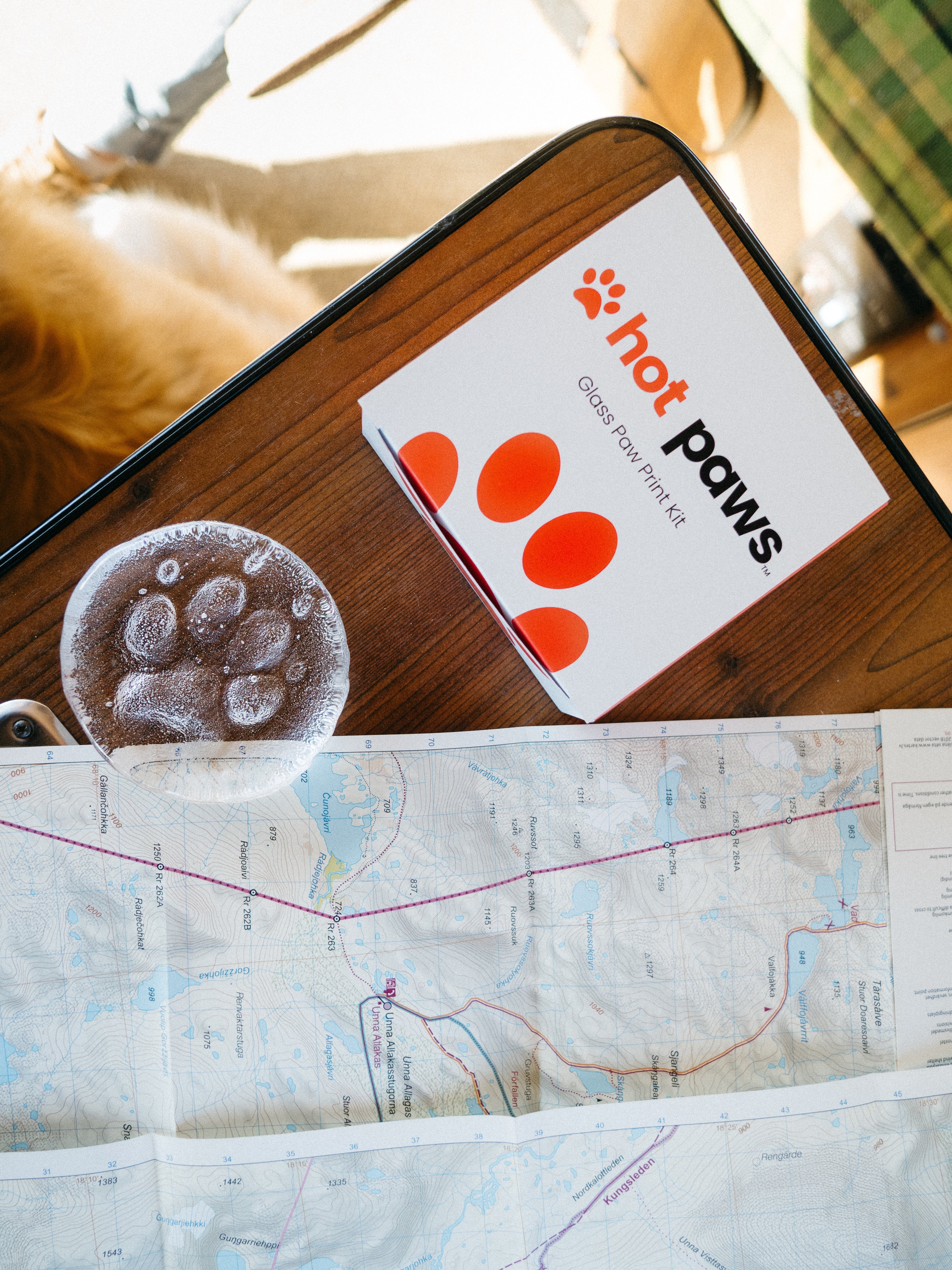 Hot Paws product packaging on a table with a map in the background